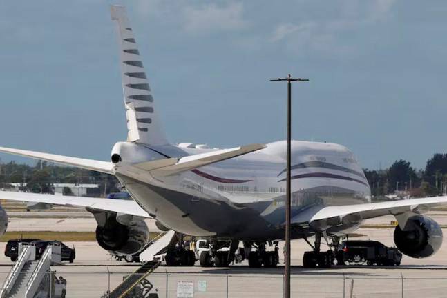 The motorcade of U.S. President Donald Trump is parked next to a 12-year old Qatari-owned Boeing 747-8 that Trump was touring in West Palm Beach, Florida, U.S., February 15, 2025. REUTERS/Kevin Lamarque/File Photo