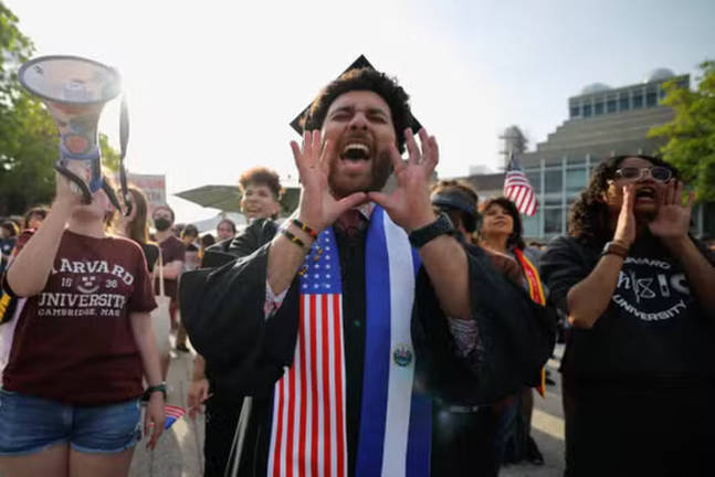 A person wears a stole with the flags of US and El Salvador as members of the Harvard community take part in a ‘Harvard Stand United’ rally to ‘support and celebrate’ the school’s international students at Harvard University in Cambridge, Massachusetts, May 27, 2025. - REUTERSpix