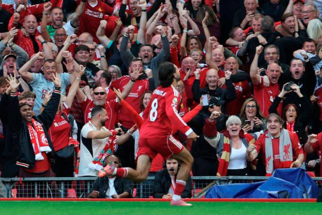 Liverpool’s midfielder Dominik Szoboszlai celebrates scoring the opening goal during the English Premier League football match between Liverpool and Arsenal at Anfield. - AFP