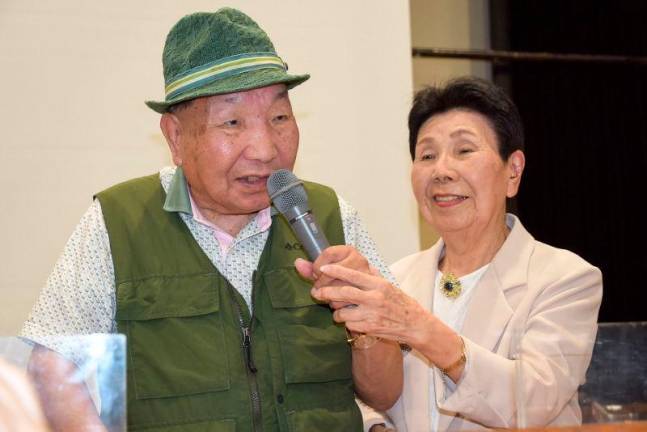 This photo taken on September 29, 2024 shows Iwao Hakamada (L) speaking as his then 91-year-old sister Hideko (R) holds the microphone during a judgement report session held by supporters in the city of Shizuoka, Shizuoka prefecture, two days after he was acquitted, more than half a century after his murder conviction,.AFPpix