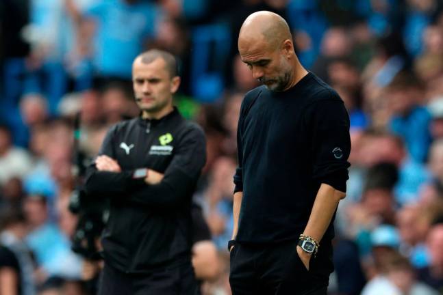 Manchester City’s Spanish manager Pep Guardiola (R) reacts during the English Premier League football match between Manchester City and Tottenham Hotspur at the Etihad Stadium. - AFP