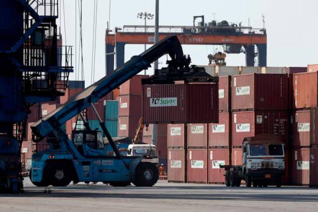 A mobile crane carries a container at Deendayal Port in Kandla, in the western state of Gujarat, India, April 5, 2025. - REUTERS
