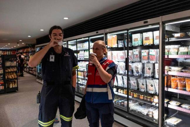 For Representational Purpose - Emergency Medical workers enjoy their coffee at Pantry, a hybrid model of petrol station, supermarket, deli, take-away and retail store in Rosebank, Johannesburg, AFPpix