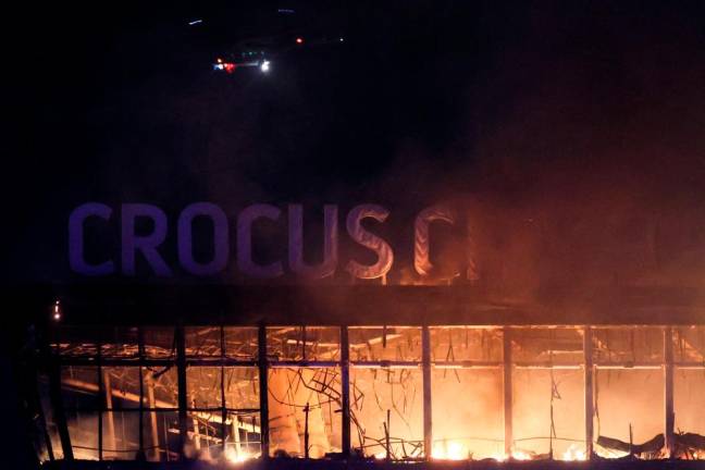 A view shows the burning Crocus City Hall concert hall following the shooting incident in Krasnogorsk, outside Moscow. - AFPPIX
