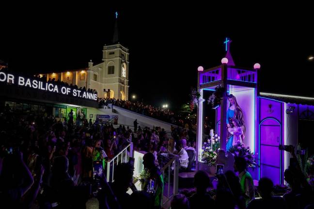 Catholics attend St Anne’s Church in Bukit Mertajam carrying candles as they attended the St Anne’s celebration last night. - Bernama