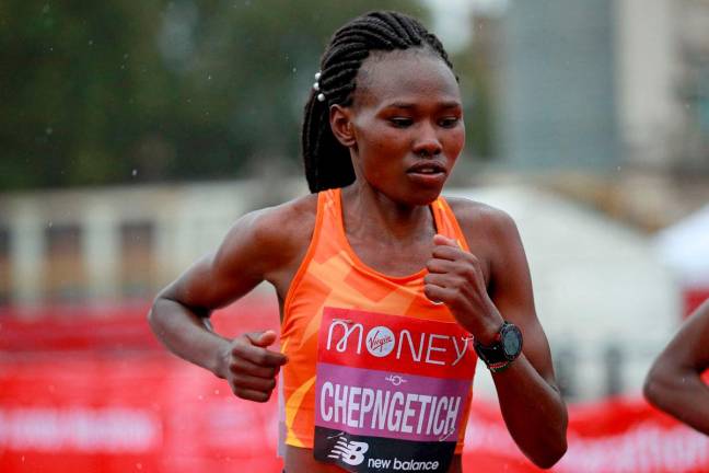 (FILES) Kenya’s Ruth Chepngetich runs in the rain early in the women’s race of the 2020 London Marathon in central London on Oct 4, 2020- AFP