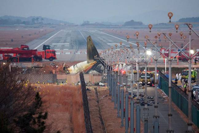 FILE PHOTO: The wreckage of the Jeju Air aircraft that went off the runway and crashed lies at Muan International Airport, in Muan, South Korea, December 30, 2024. - REUTERS/Kim Hong-Ji/File Photo