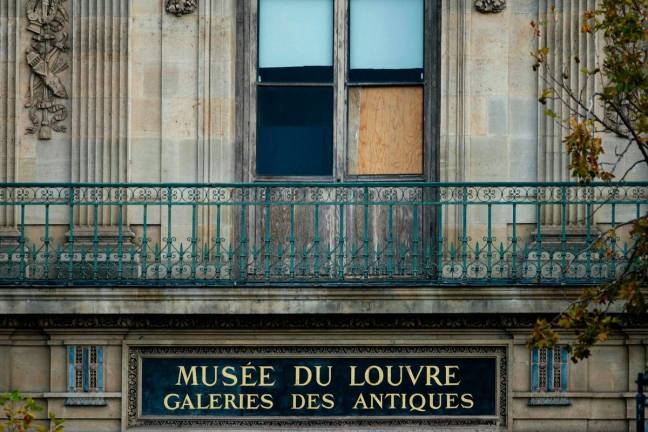 The window of the Louvre Museum is seen with the glasses covered after the thieves broke them to get in and steal priceless jewels. - AFP pic