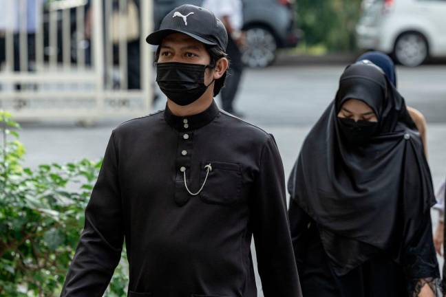 Parents to autistic child Zayn Rayyan Abdul Matiin, Ismanira Abdul Manaf (right) and Zaim Ikhwan Zahar at the Petaling Jaya Sessions Court during an earlier hearing. - Bernama pix
