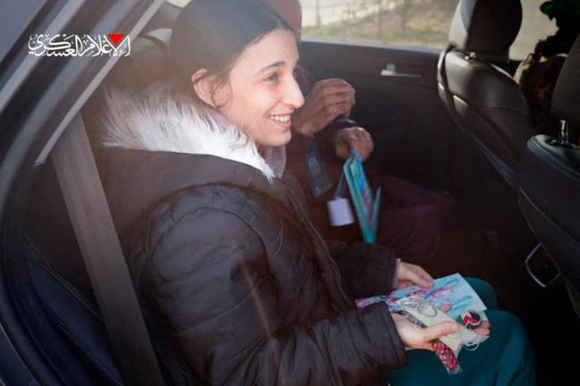 This handout image released by the Hamas Media Office on January 30, 2025, shows Israeli-German national Arbel Yehud, 29, who was held hostage in Gaza since October 2023, during her handover to a Red Cross team in Khan Yunis as part of a third hostage-prisoner exchange. - AFP PHOTO / HO / HAMAS MEDIA OFFICE