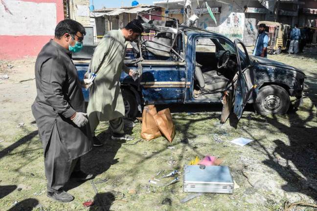 Security personnel inspect the blast site near a girls' school targeting police guarding polio vaccinators in the city of Mastung in Balochistan province on November 1, 2024. A bombing near a school in western Pakistan killed seven people, including five children, in an attack targeting police guarding polio vaccinators on November 1, officials said. - Banaras KHAN / AFP