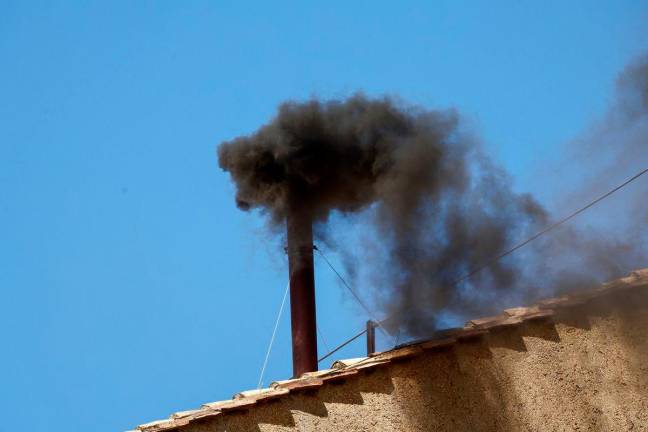 Black smoke rises from the chimney on the Sistine Chapel, indicating no decision has been made to elect a new pope, at the Vatican, May 8, 2025. REUTERS/Yara Nardi