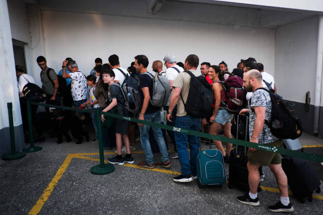 Citizens repatriated from Israel disembark a flight from Egypt at Figo Maduro airport in Lisbon on June 19, 2025. - AFP