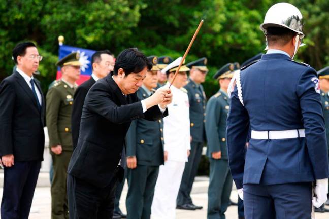 Taiwan's President Lai Ching-te (C) attends a ceremony commemorating the 75th anniversary of the Battle of Guningtou in Kinmen on October 25, 2024. Taiwan President Lai Ching-te said on October 25 the island will not cede in defence of its territory, as China maintains military pressure on Taipei to accept its claim of sovereignty. - I-Hwa CHENG / AFP