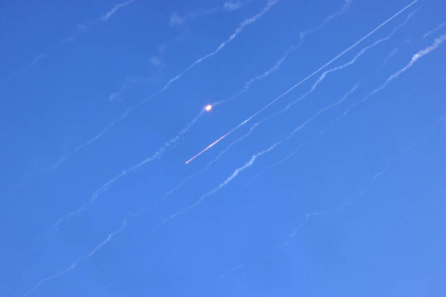 Missiles fired from Iran are pictured over Hebron in the occupied West Bank on June 19, 2025. Israel’s foreign ministry reported a direct hit on a hospital in the south on June 19, after Iran fired a fresh salvo of missiles at the country. - AFP