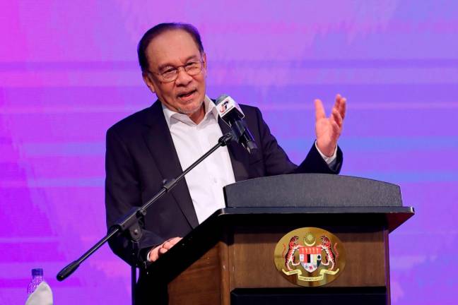Prime Minister Datuk Seri Anwar Ibrahim delivering a speech during the monthly meeting with the Prime Minister Department staff for the month of July at the Puspanitapuri, Putrajaya, today. - Bernama