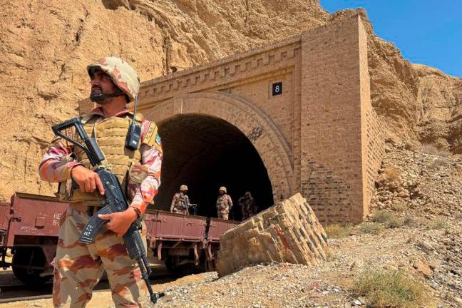 Pakistan army soldiers stand at a tunnel where the Jaffar Express train was attacked by separatist militants, in Bolan, Balochistan, Pakistan, March 15, 2025. REUTERSpix