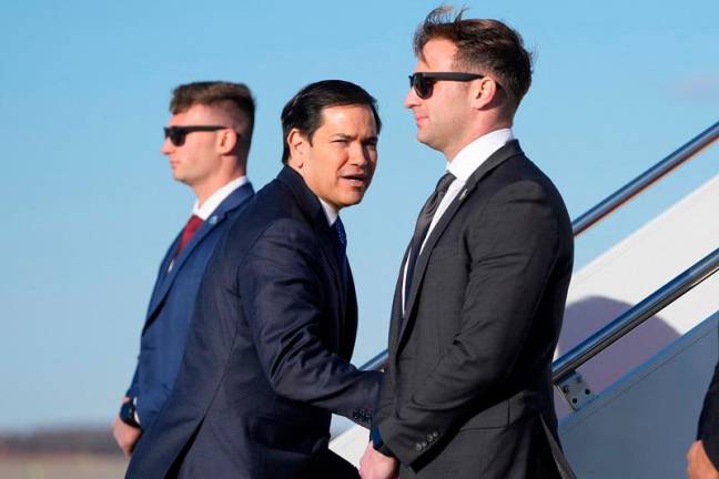 US Secretary of State Marco Rubio (C) boards a plane on February 1, 2025 at Joint Base Andrews in Maryland en route to Panama. Rubio is making his first trip as secretary of state, traveling to five small Latin American nations to aggressively push President Donald Trump’s doctrine of US self-interest, starting with the Panama Canal, after Trump charged that China has unfair influence over the canal and vowed that the United States would be “taking it back.” - Mark Schiefelbein / POOL / AFP