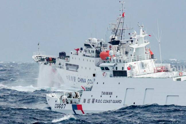 This handout photo taken and released by Taiwan's Coast Guard on December 12, 2024 shows a Taiwanese coast guard ship (R) monitoring a Chinese coast guard ship, a few nautical miles from Taiwan's northeastern coast. Chinese navy and coast guard ships have returned to China, signalling the end of a massive maritime exercise, Taiwanese authorities said on December 13. - AFP PHOTO / TAIWAN COAST GUARD