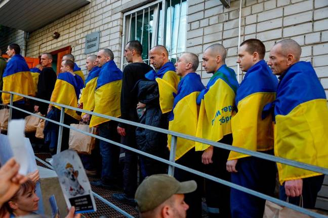 Ukrainian prisoners of war (POWs) are seen after they return after a swap, amid Russia's attack on Ukraine, in an undisclosed location in Ukraine, May 23, 2025. - REUTERS/Valentyn Ogirenko