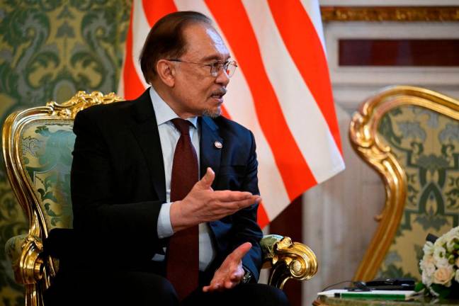 Malaysian Prime Minister Anwar Ibrahim speaks during a meeting with Russian President Vladimir Putin at the Kremlin in Moscow, Russia May 14, 2025. Alexander Nemenov/Pool via REUTERS