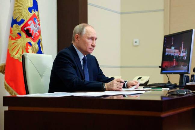 In this pool photograph distributed by the Russian state agency Sputnik, Russia's President Vladimir Putin chairs a meeting with members of the government via videoconference at the Novo-Ogaryovo state residence outside Moscow on January 9, 2025. - Alexander KAZAKOV / POOL / AFP