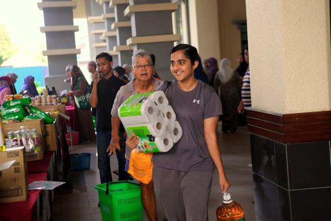 Purchasers getting essential goods during the Rahmah Madani Sales Programme (PJRM) in Ipoh, last month. - Bernama file pic