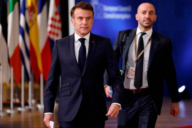 France’s President Emmanuel Macron (L) and France’s Delegate Minister for Europe Benjamin Haddad . AFPp[ix