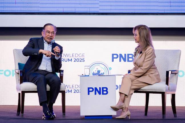 Prime Minister, Datuk Seri Anwar Ibrahim (left) during the ‘In Conversation with Datuk Seri Anwar Ibrahim’ session conducted by moderator Lorraine Hahn at the PNB Knowledge Forum 2025 today. - Bernama pic