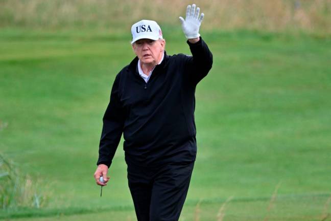 US President Donald Trump reacts as he plays golf at the Trump Turnberry Golf Courses, in Turnberry on the south west coast of Scotland on July 26, 2025, during the second day of his visit to the country, since his second tenure as President began. - AFP