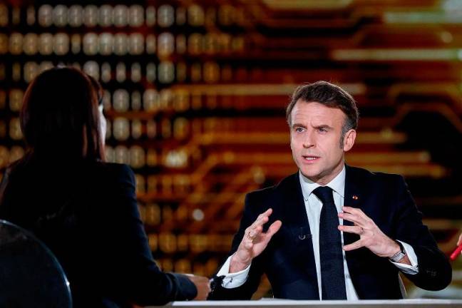 French President Emmanuel Macron answers questions of journalists during a televised interview broadcasted on TV channel France 2 and in India on the eve of the Artificial Intelligence (AI) Action Summit, at the Grand Palais, in Paris, on February 9, 2025. - Gonzalo Fuentes / POOL / AFP