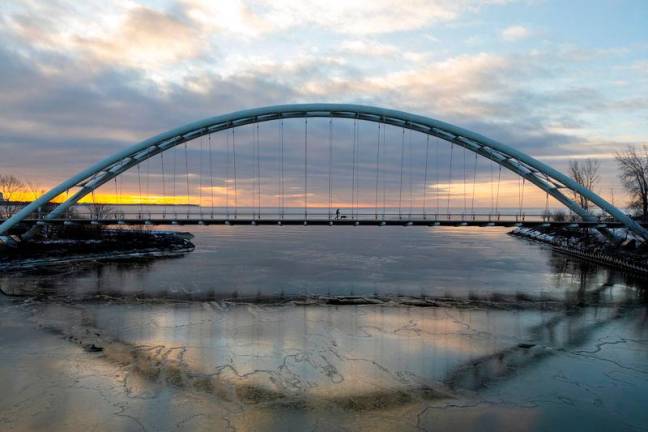 A drone picture shows a person crossing the Humber Bay Arch Bridge during sunrise in Toronto, Ontario, Canada March 2, 2025. REUTERSpix