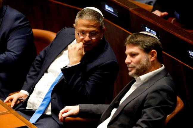 FILE PHOTO: Right-wing Knesset members Itamar Ben-Gvir and Bezalel Smotrich attend a special session at the Knesset Israel's parliament, to approve and swear in a new right-wing government, in Jerusalem December 29, 2022. - REUTERS/Amir Cohen/Pool/File Photo