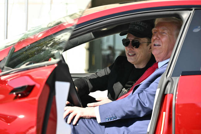 US President Donald Trump and Tesla CEO Elon Musk speak to the press as they sit in a Tesla vehicle on the South Portico of the White House on March 11, 2025 in Washington, DC. - AFPpix