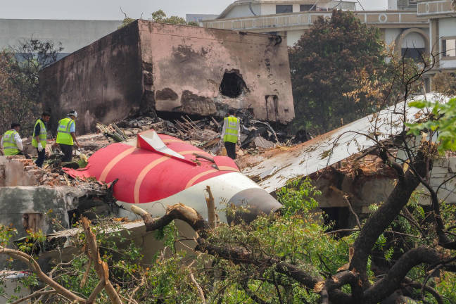 An investigation team inspects the wreckage of Air India flight 171 a day after it crashed in a residential area near the airport, in Ahmedabad on June 13, 2025. - AFPpix