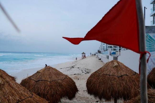 A red flag is seen at a tourist beach ahead of the arrival of Hurricane Beryl, in Cancun, Mexico July 4, 2024. - REUTERSpix