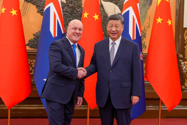 A handout photo taken and received on June 20, 2025 from the New Zealand Office of the Prime Minister shows New Zealand’s Prime Minister Christopher Luxon (L) meeting Chinese President Xi Jinping (R) at the Great Hall of the People in Beijing. - via AFP