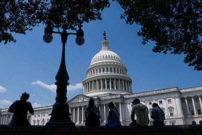 Visitors to the U.S. Capitol rest in the shade on Capitol Hill in Washington, D.C., U.S., June 25, 2025. - REUTERS