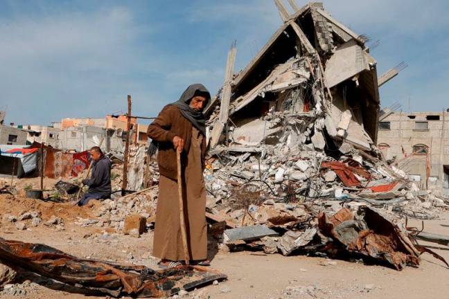 A Palestinian man walks near rubble of houses destroyed during the Israeli offensive, in Rafah, in the southern Gaza Strip. REUTERSpix