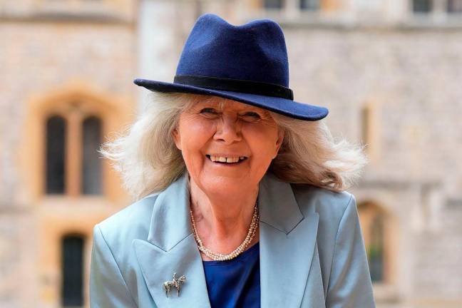 (FILES) British author Jilly Cooper poses after being appointed a Dame Commander of the Order of the British Empire (DBE) following an investiture ceremony at Windsor Castle, southern England, on May 14, 2024. Author Dame Jilly Cooper has died at the age of 88, a spokesperson has said, October 6. (Photo by ANDREW MATTHEWS / POOL / AFP)