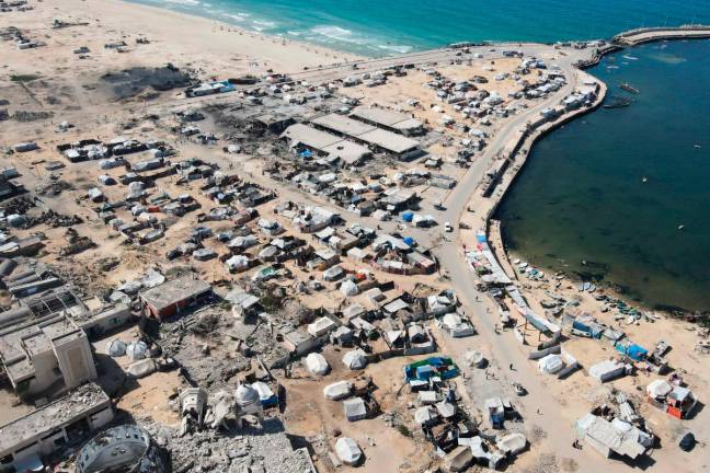 An aerial view shows tents sheltering displaced Palestinians in the war-damaged area surrounding Gaza City’s port on October 20, 2025, during a US-brokered ceasefire between Israel and Palestinian factions. - AFP