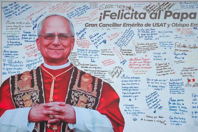 Messages are written on a banner with an image of Pope Leo XIV at the Santo Toribio de Mogrovejo Catholic University in Chiclayo, Lambayeque region, northern Peru, on May 12, 2025. – AFPpix