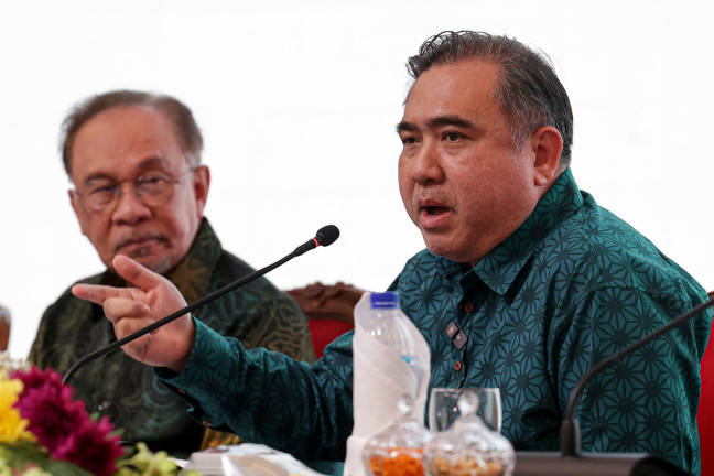 Prime Minister Datuk Seri Anwar Ibrahim listens to a speech by Transport Minister Anthony Loke during the Ilmuwan Malaysia MADANI Series 6 Forum titled “Transportation for the People: Balancing Affordability, Quality, and Sustainability of Public Transport” at Menara Prasarana today. - BERNAMApix