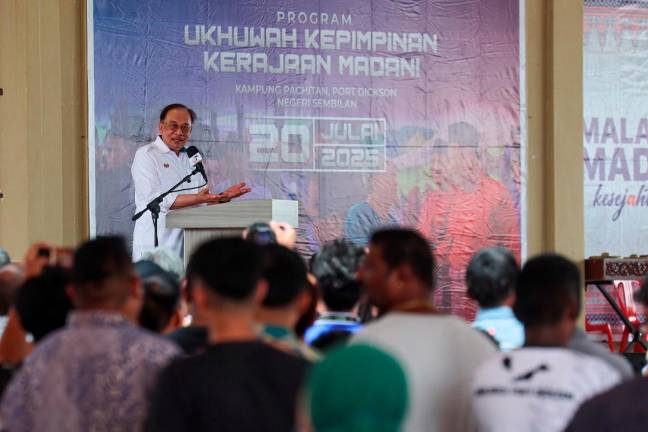 Prime Minister Datuk Seri Anwar Ibrahim speaking during the Kenduri Rakyat ceremony in conjunction with the MADANI Ukhwah Programme in Kampung Pachitan, Port Dickson today. - Bernama pic
