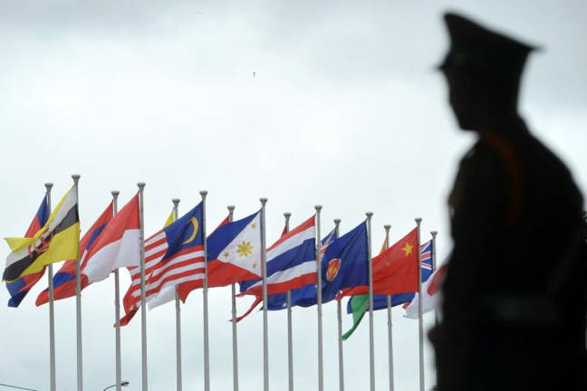 Lao police security stands guard at the entrance to the Association of Southeast Asian Nations (Asean) Summit in Vientiane on Sept 7, 2016. - AFPpix