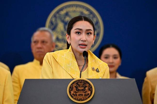 Thailand's new Prime Minister Paetongtarn Shinawatra (C), known by her nickname Ung Ing and daughter of former prime minister Thaksin Shinawatra, addresses the media after a special cabinet meeting at Government House in Bangkok on September 7, 2024. Paetongtarn Shinawatra, the heiress of Thailand's most famous political dynasty, was sworn in as prime minister on September 6, capping a month of turmoil in which her predecessor was thrown out of office and the main opposition party dissolved. - MANAN VATSYAYANA / AFP