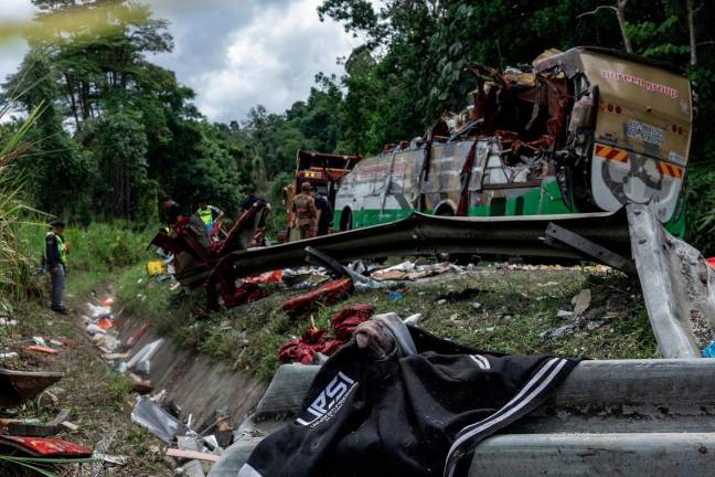 The situation at the scene of the accident that claimed the lives of 15 individuals at KM53 of the East-West Highway (JRTB) near Gerik, yesterday. - Bernama pic