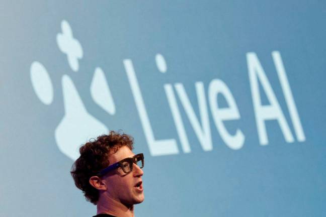Meta CEO Mark Zuckerberg wears the Meta Ray-Ban Display glasses, as he delivers a speech presenting the new line of smart glasses, during the Meta Connect event at the company’s headquarters in Menlo Park, California, U.S., September 17, 2025. REUTERS/Carlos Barria