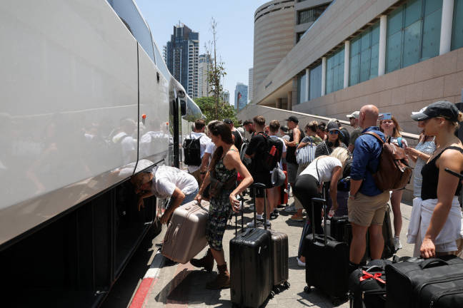 People with foreign nationalities prepare to leave Israel via Egypt on a bus, following a missile attack from Iran, in Tel Aviv, Israel, June 17, 2025. - REUTERSpix