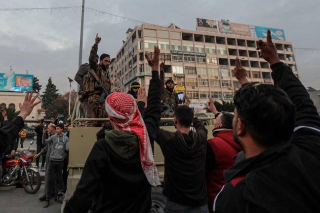 Residents take to the streets of Hama, to welcome anti government fighters after they took control of Syria's west-central city on December 5, 2024. Islamist-led rebels captured the central Syrian city of Hama on December 5, days after seizing the country's commercial hub Aleppo in a lightning offensive against President Bashar al-Assad's forces. - Bakr ALKASEM / AFP